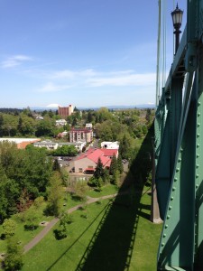 The St Johns Bridge casts a fantastic shadow over Cathedral Park, with Mt. Saint Helens and Mt. Adams in the distance.
